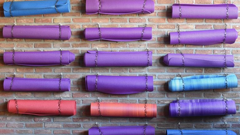 coloured yoga mats on a wall