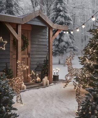 entrance to cabin with snow and christmas lights