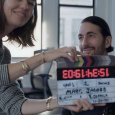 sofia coppola holds a clapper board in front of marc jacobs as he gets ready for an interview in the documentary marc by sofia