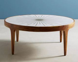 A round coffee table in marble with brass detailing