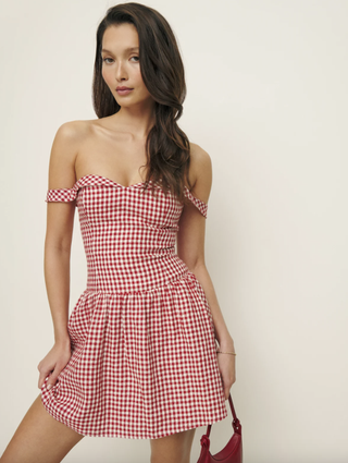 a model wears a gingham reformation dress that taylor swift owns to the us open