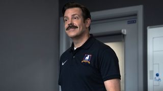 Jason Sudeikis as Ted Lasso with a small smile in Ted Lasso Season 4.