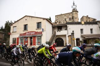 The pack of riders cycles past a bakery during the 6th stage of the Paris-Nice cycling race, 209,8 km between Saint-Julien-en-Saint-Alban and Berre lâ€™Ã‰tang, on March 14, 2025. (Photo by Anne-Christine POUJOULAT / AFP)