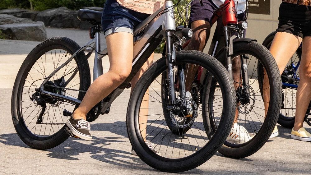 Three people with Schwinn Marshall electric bikes