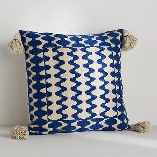 blue patterned pillow with tassels 
