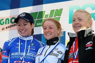 A smiling Emma Pooley on the top step of a World Cup race