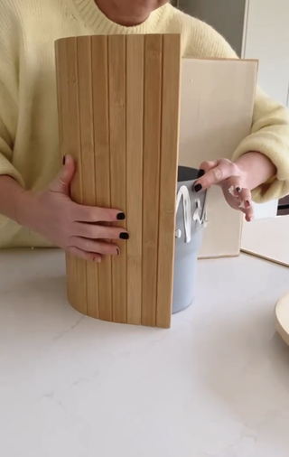 A side table being made with flexible wood around a pot