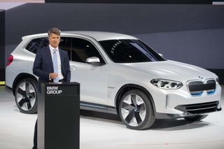 Harald Krueger, chairman of the board of management of BMW AG, presents the BMW iX3 concept car during a press conference at the Beijing Auto Show in Beijing on April 25, 2018. - Industry beh