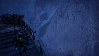 A knight descends a staircase in Lord of the Fallen's Umbral realm, while a giant corpse clings to the mountainside in the distance.
