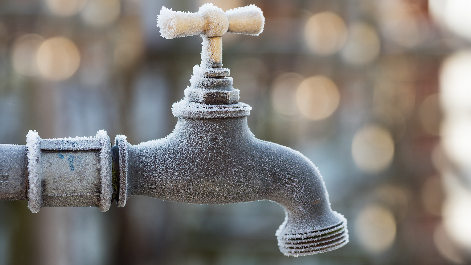 Frost on outdoor faucet or spigot on a winter morning