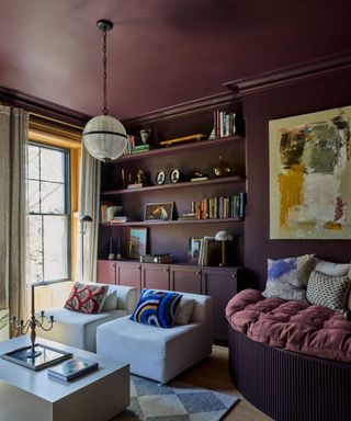 purple snug family room with painted ceiling and cozy seating