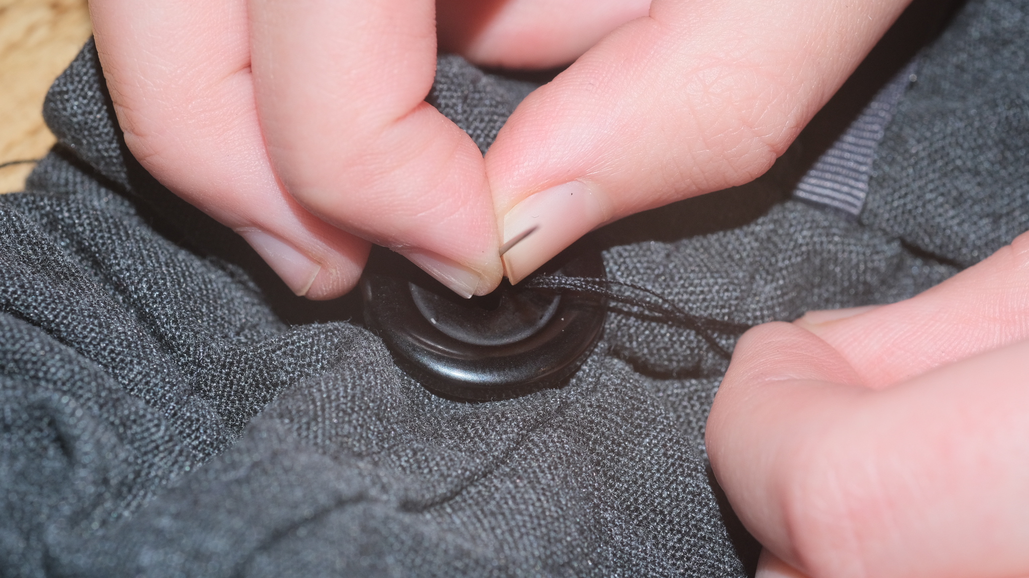 A button being sewn on