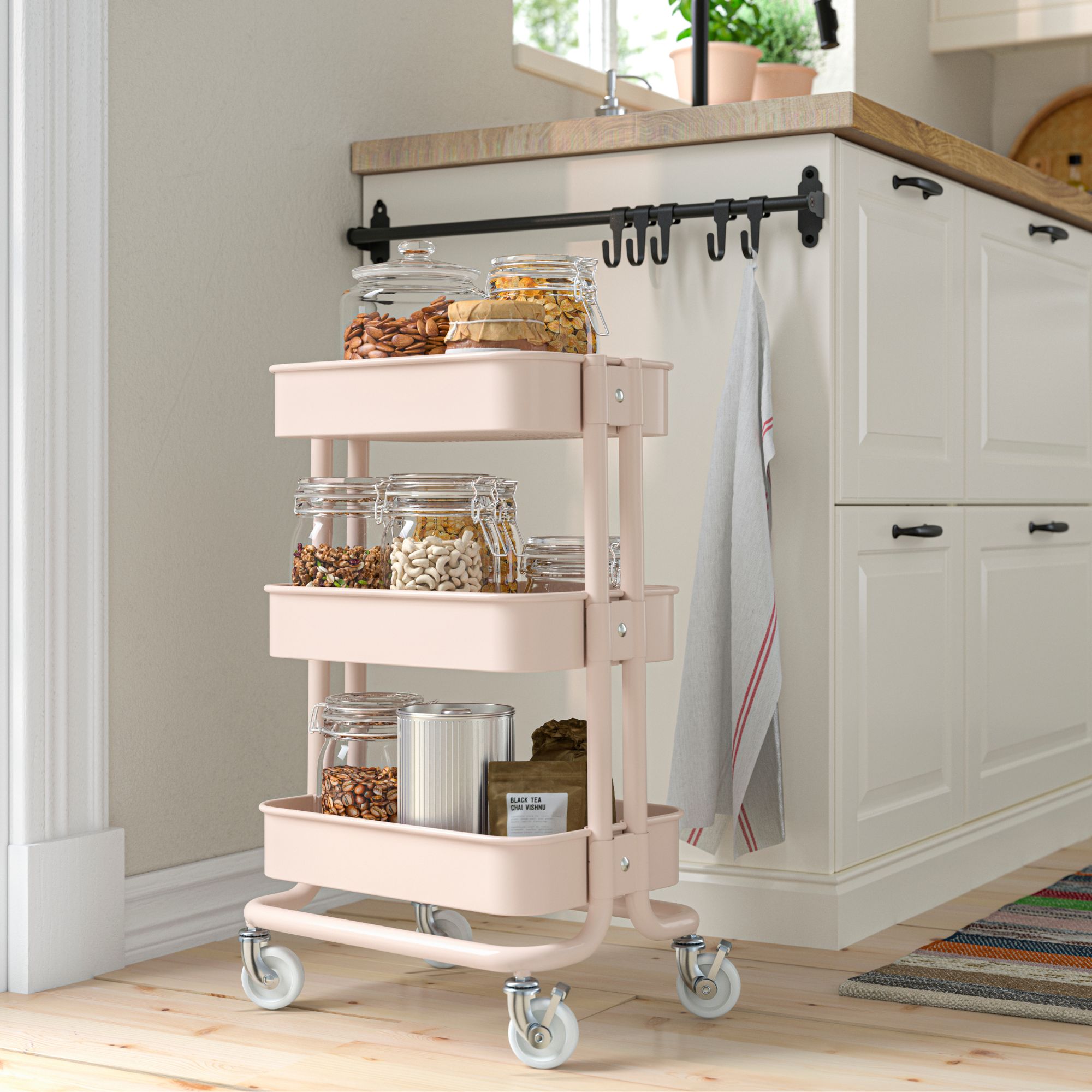 IKEA RASKOG trolley in pastel pink against a white kitchen unit