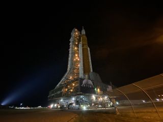 NASA's Artemis 1 Space Launch System moon rocket on its crawler carrier and mobile launch platform as it heads to the launch pad.