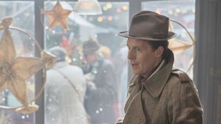 Christopher Harper as Geoffrey wears a brown hat and coat in Call the Midwife.