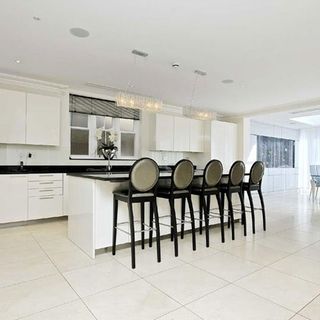 kitchen room with white tiled flooring and white cabinets