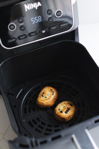 Cooked croissant Rolls in the open drawer of the Ninja Air Fryer XL Pro