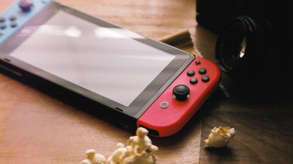 NIntendo Switch on a table with popcorn