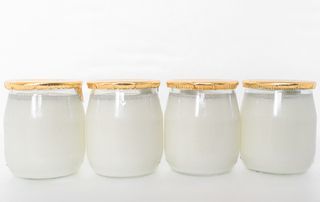 Four pots of Greek yogurt