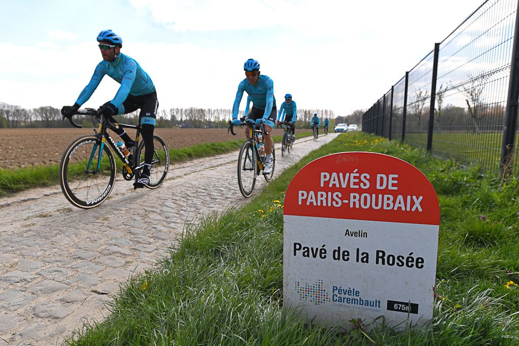 Astana riders check out a section of Paris-Roubaix cobbles.
