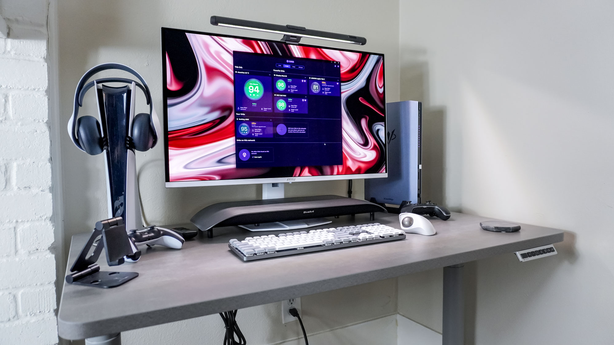 The Orb app running on the AtomMan G7 Ti mini PC at a gaming-focused desk setup