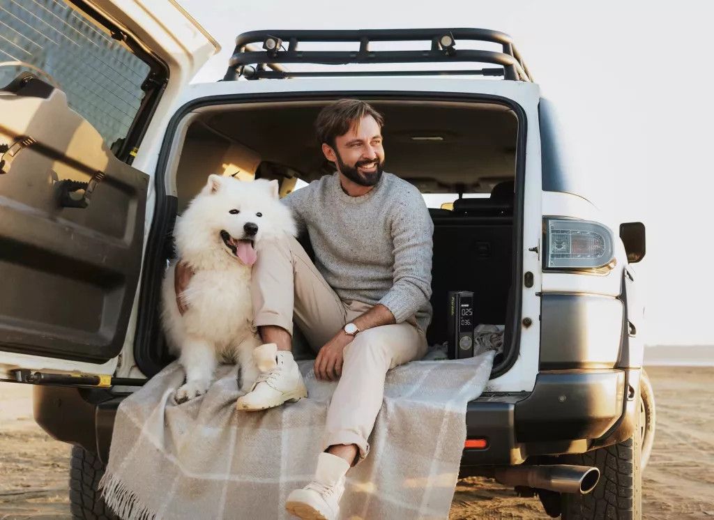 A man with a dog in a car