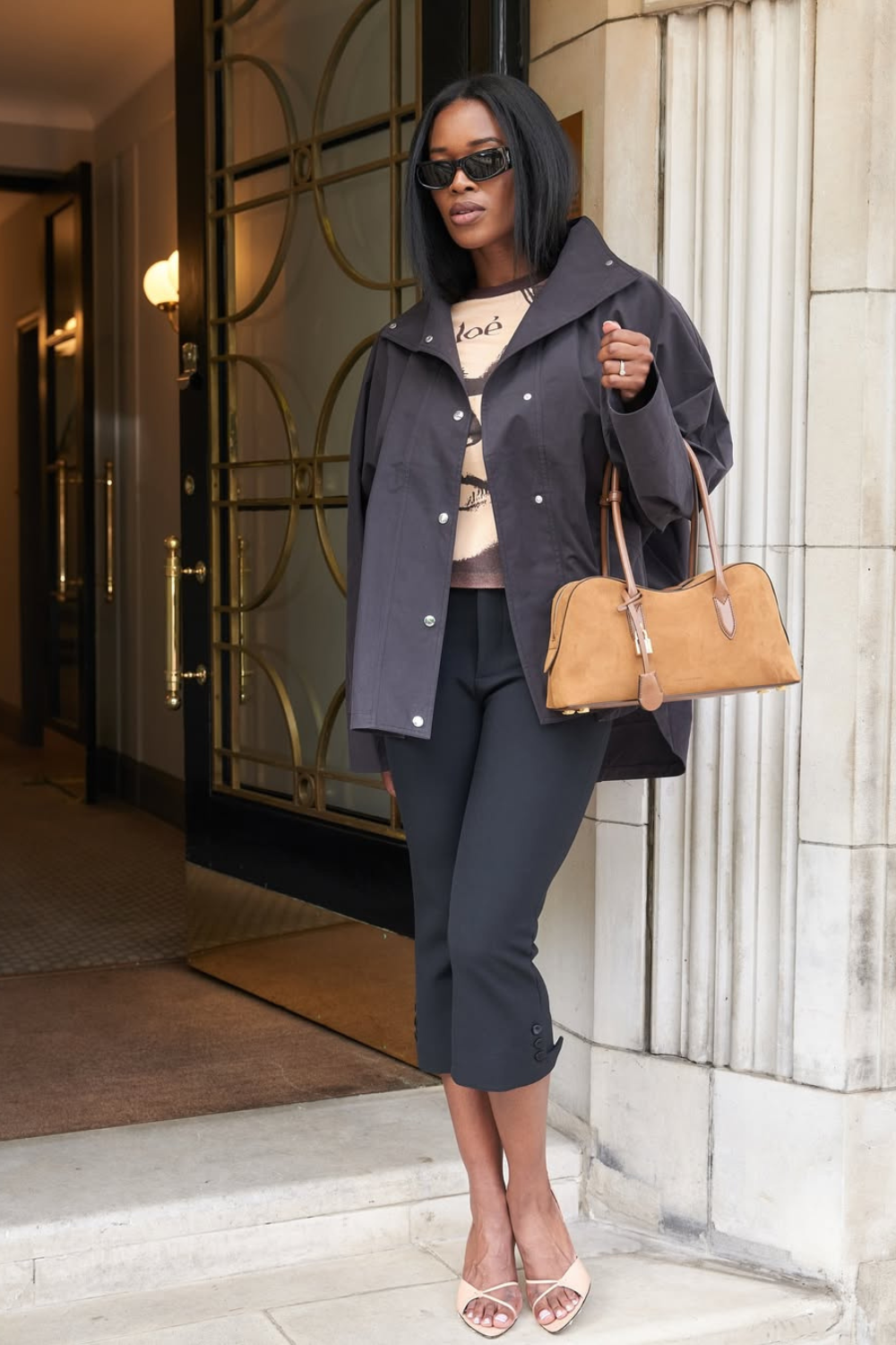 @nlmarilyn wears black capri pants, black jacket