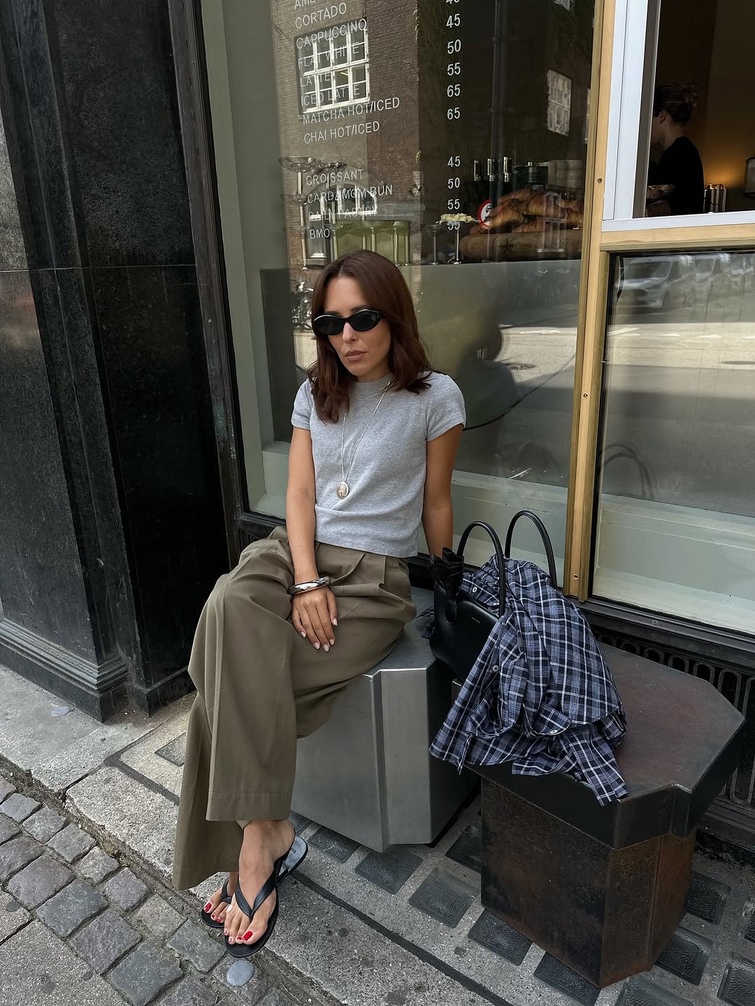 Woman wearing plaid jacket trend fall 2025.