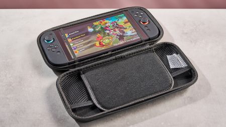 The Nintendo Switch 2 sits inside the Snakebyte Starter Kit S2 case, with Mario Kart World showing on its screen.