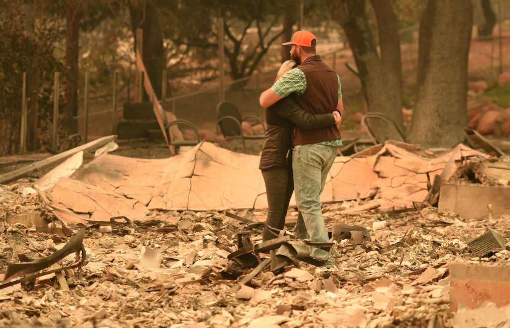 A couple reacts to their home burning down.