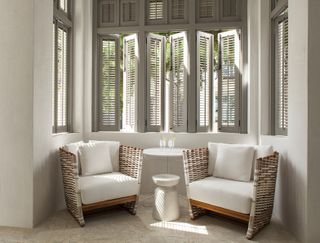 A window seat with shutters painted gray