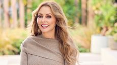 Carol Vorderman in a light brown jumper smiling at the camera 