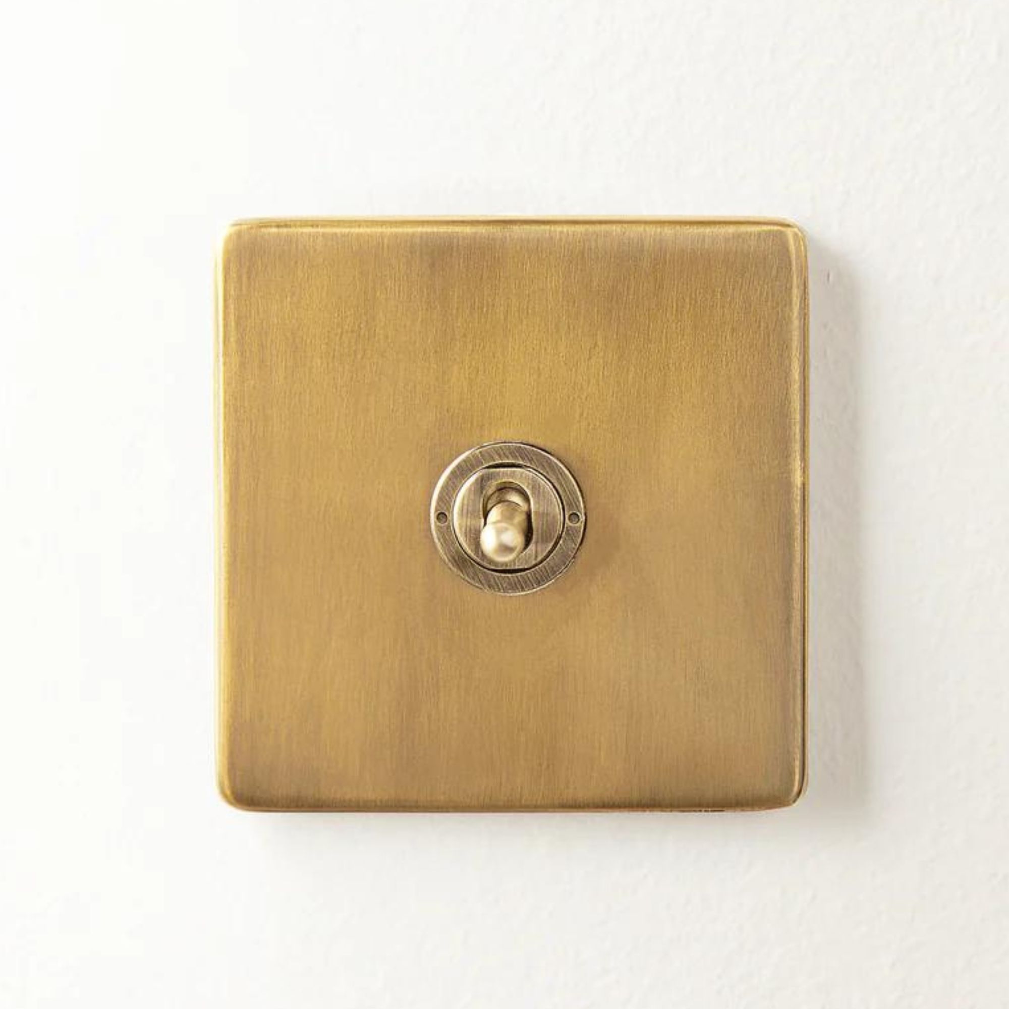 A brushed metal light switch with a toggle switch 