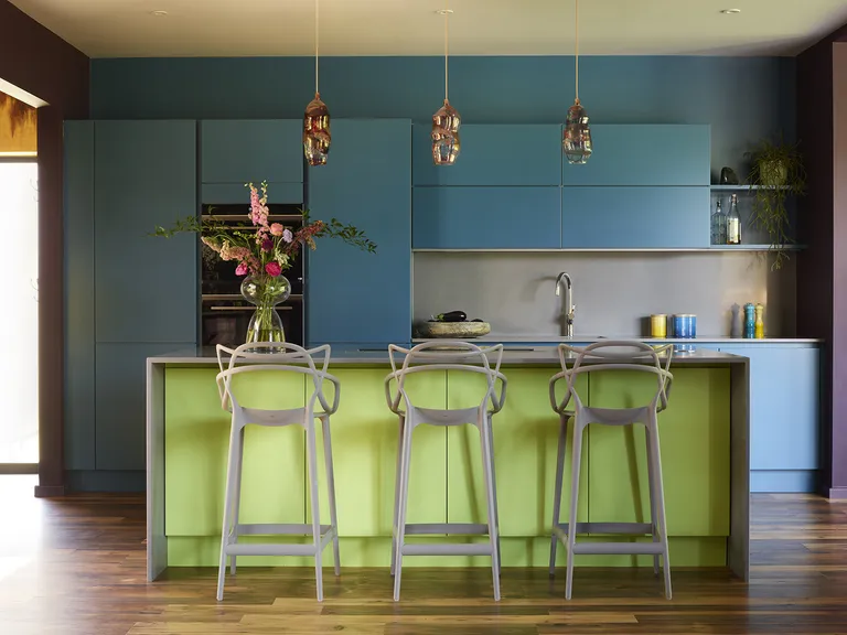 modern kitchen with green island and blue cabinets