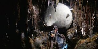 Harrison Ford as Indiana Jones outrunning a boulder in Raiders of the Lost Ark