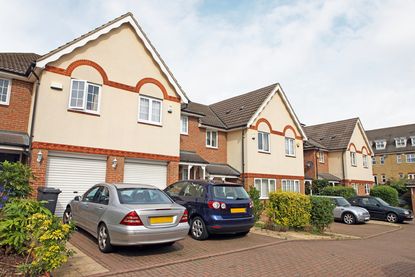 New build homes with cars parked in the driveways