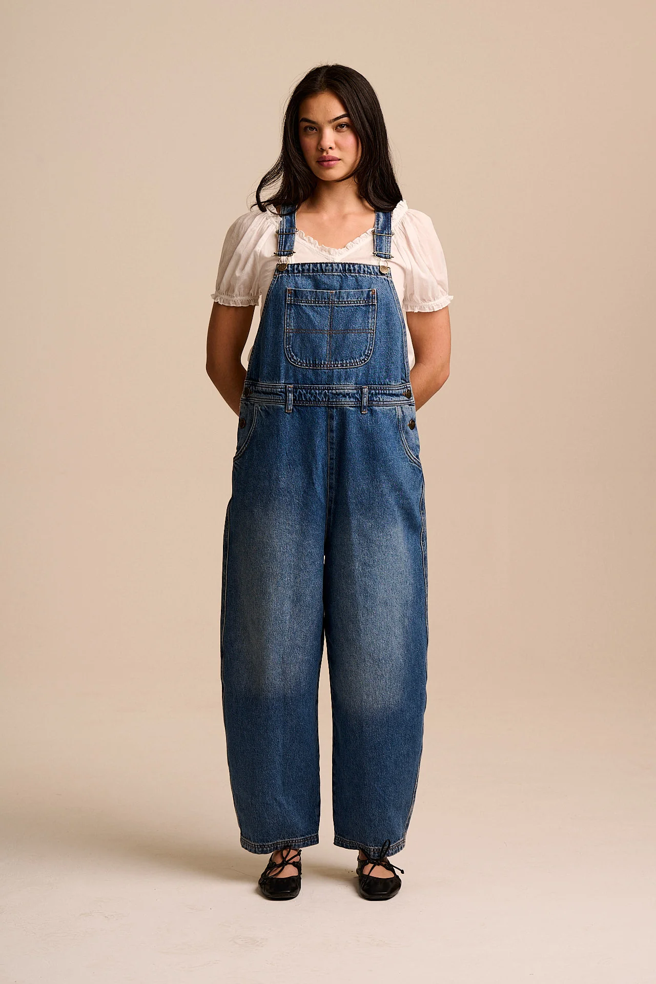 A model wearing barrel leg denim overalls from Lucy &amp;amp; Yak