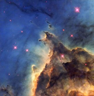 Dust in nebula NCG 2174 appears in mountain-like formations, though the structures have no more substance than air. Nearby bright, newly formed stars emanate light and winds that disperse the