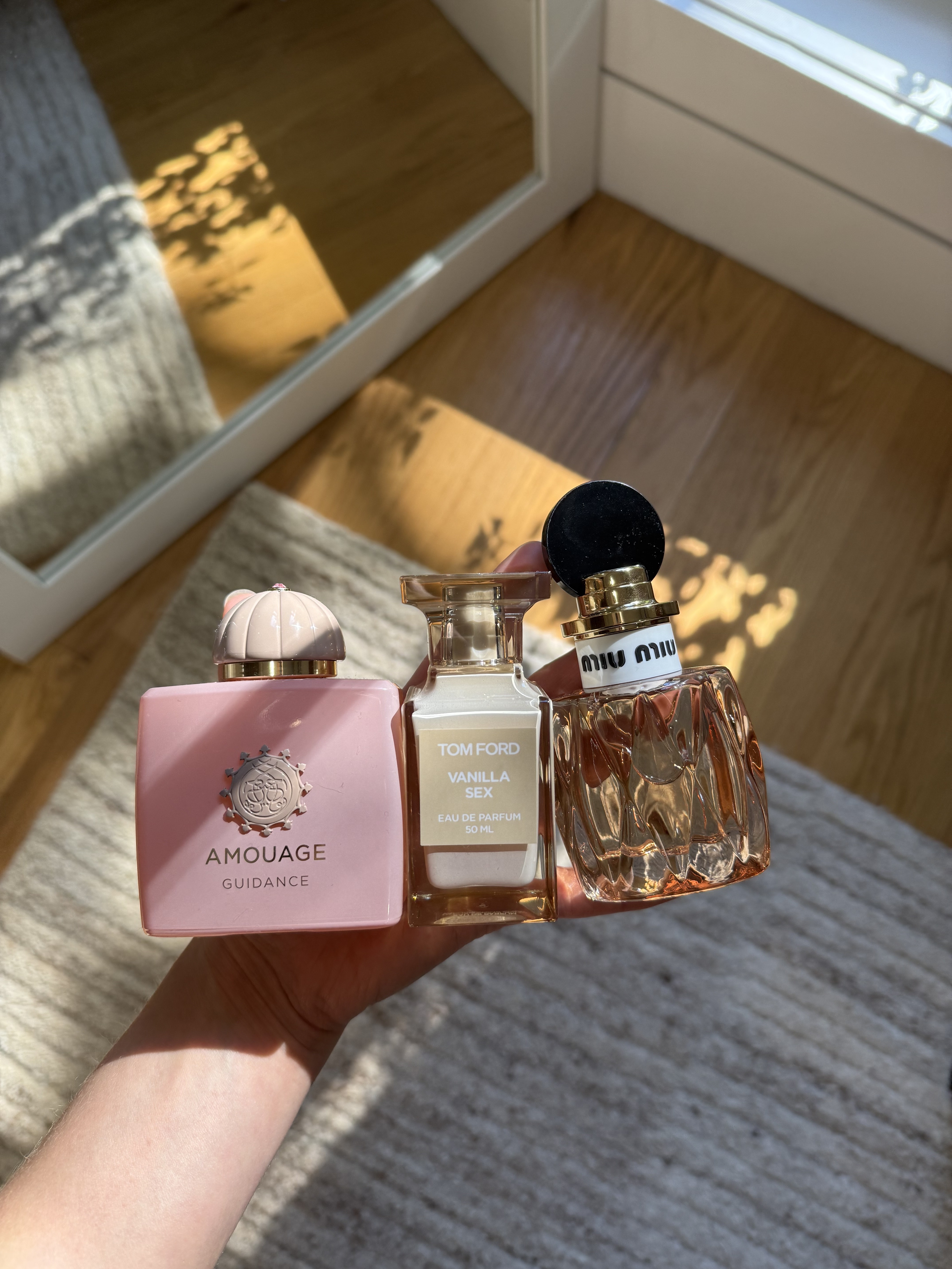 Photo of Jamie Schneider holding her most complimented perfumes