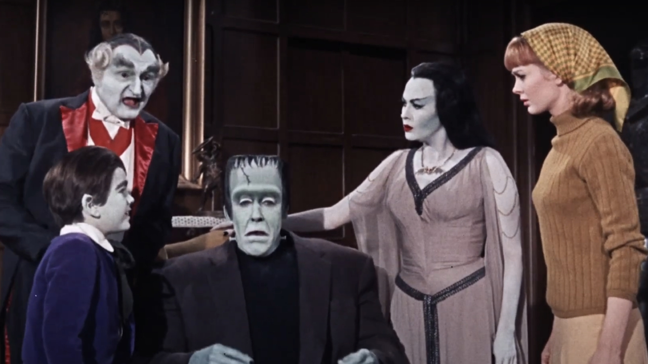 The Munsters gathered together lookign concerned in Munster, Go Home!