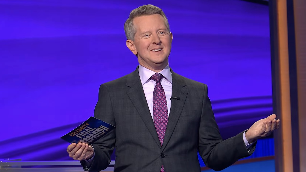 Ken Jennings holding arms apart while hosting Celebrity Jeopardy! Season 4