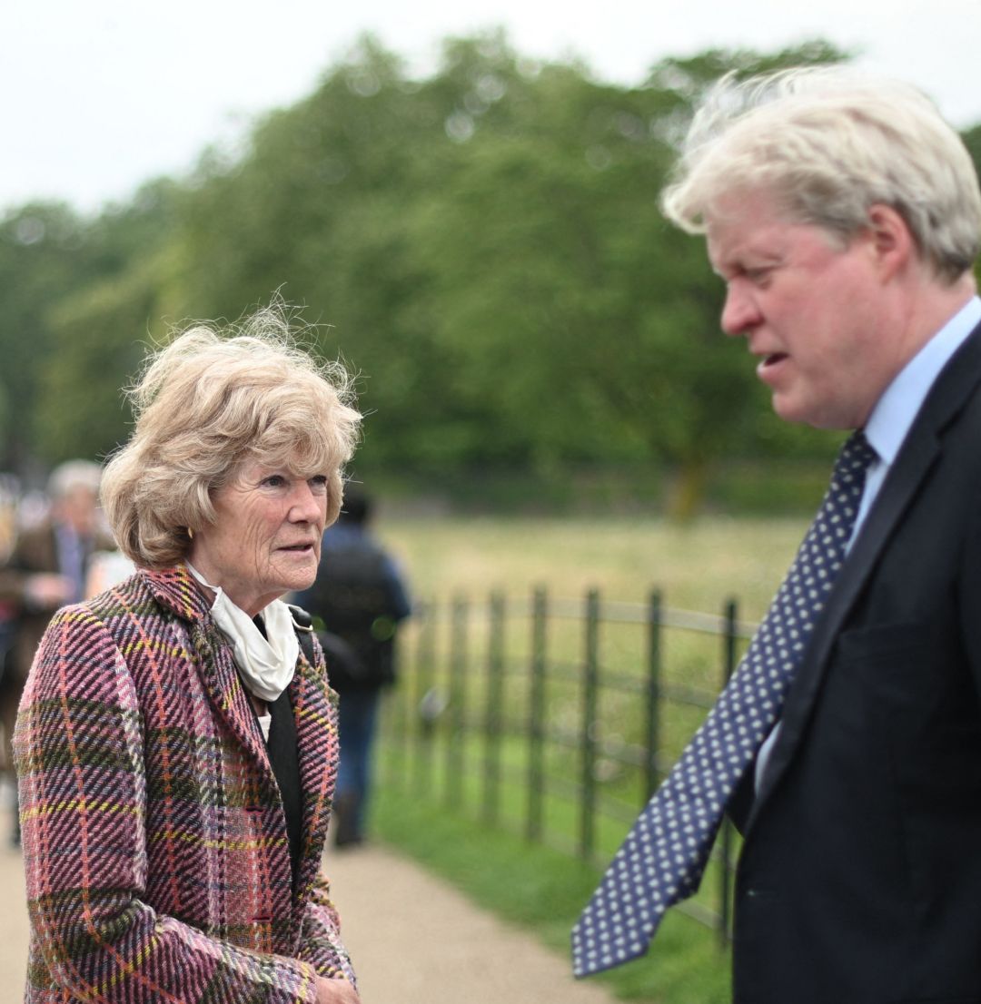 Earl Spencer and his sister Sarah outside Kensington Palace next to a police officer