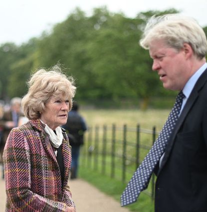 Earl Spencer and his sister Sarah outside Kensington Palace next to a police officer