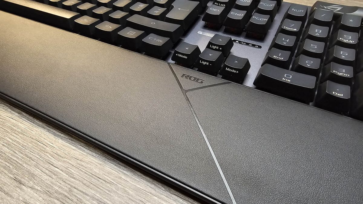 The Asus ROG Strix II RX gaming keyboard photographed on a wooden desk.