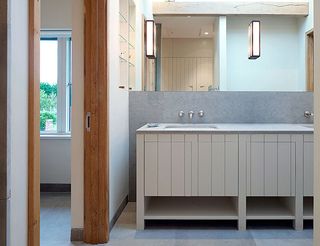 Bathroom view of double sink on white cupboard