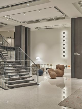 D Studio Milano with staircase leading to the first floor and Gaetano Pesce's armchairs for B&B Italia on one side