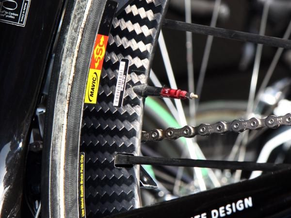 Mechanics employ a variety of tricks to quell rattling valve stems. Here, a Garmin-Cervelo mechanic has simply built up the diameter of the valve stem before mounting the tire.