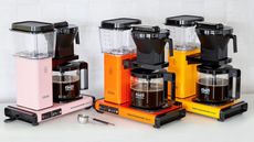 Three Moccamaster Filter KBG Select Coffee Makers in pink, orange and yellow