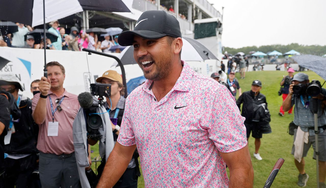 Day walks off the 18th green after holing the winning putt