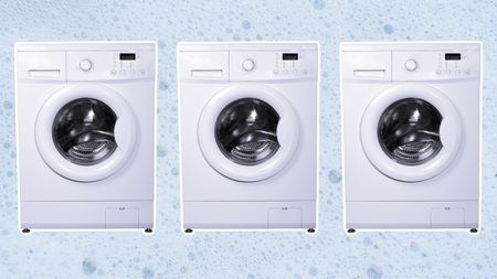 Three washing machines on soapy background